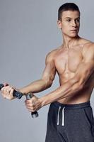 sporty man with dumbbells in hands workout pumped up press cropped view photo