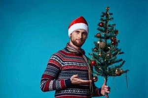 handsome man in a santa hat holding a banner holiday isolated background photo