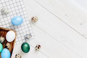 easter eggs of different colors lie on a wooden table Copy Space photo