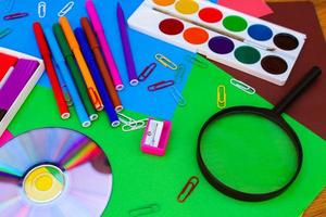 Stationery objects. School and office supplies on the background of colored paper. photo