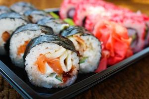 Sushi roll with salmon, cucumber, cheese, and caviar fish photo