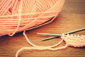 beige yarns and knitting needles. Toned image. photo