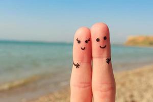 Finger art of a Happy couple. Man and woman have a rest on the beach sea. Man and woman hug on the background sea. photo