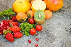 Fruits, vegetables on wooden background photo