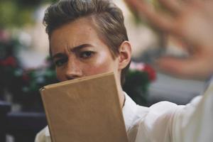 short haired woman reading walk in the fresh air education photo