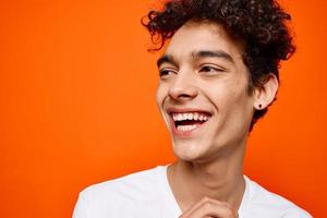 guy with curly hair in a white t-shirt emotion grimace photo