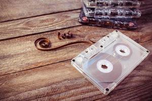 Audio cassette on the old wooden background. Toned image. photo