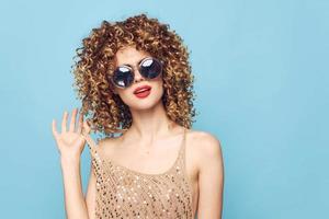 woman Curly hair sunglasses fashionable luxury clothing red lips photo