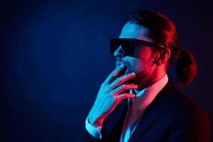 stylish man modern style suit fashion sunglasses neon light photo