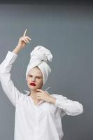 portrait of a woman red lips towel on head makeup isolated background photo