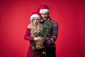 merry married couple celebrate christmas new year red background photo