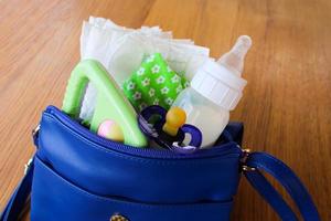 Women's handbag with items to care for the child photo
