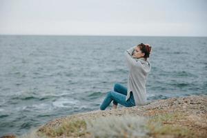 beautiful woman sweaters cloudy sea admiring nature female relaxing photo