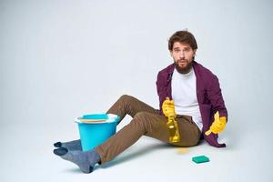 Cleaner with a bucket on the floor professional detergent service photo