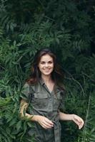 Woman in forest Jumpsuit smile green bushes fresh air photo