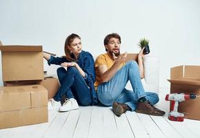 man and woman on the floor with boxes planning moving to apartment photo