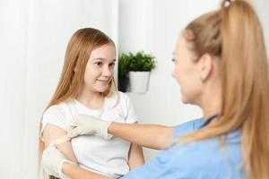 female doctor next to girl treatment health hospital photo