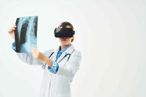 female doctor in white coat x-ray virtual reality glasses technology hospital photo