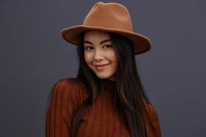 beautiful woman brown hat hand gestures brown sweater fashion emotions studio model photo