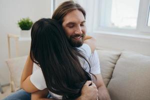 The man hugs the girl and smiles. The joy of using the family and the good psychological state after the quarrel photo