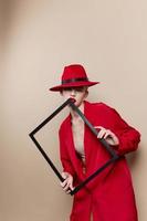 glamorous woman frame in hand in red hat and jacket Lifestyle posing photo