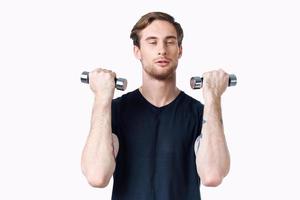 athlete with dumbbells in his hands and in a black t-shirt exercise fitness bodybuilder photo