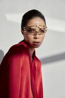 woman in red jacket with glasses accessory on face cropped view model photo