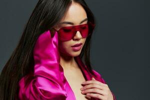 young woman in pink dress red glasses fashion makeup glamor isolated background photo