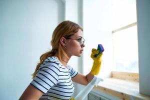 cleaning lady with a sponge in her hands home care service detergent window cleaning photo