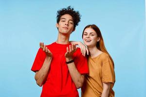 man and woman in multicolored t-shirts fashion posing blue background photo