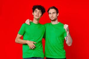 two friends hugging in green T-shirts Friendship team communication photo
