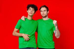 two friends hugging in green T-shirts Friendship team communication photo