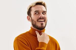 Cheerful man holding hand on face cropped view close-up photo