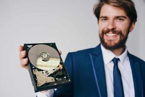 man holding a hard drive information protection technology photo