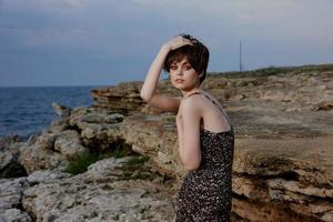 woman with makeup in dress on nature rocks landscape outdoors photo