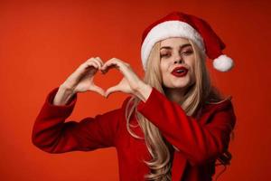 woman wearing christmas clothes fun holiday posing red background photo