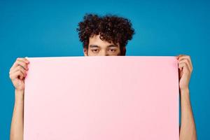 Cheerful guy with pink mockup Poster Copy Space blue background photo