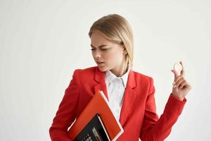 financier in a red jacket with documents in hand light background photo