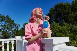 Delighted young girl with pink hair summer cocktail refreshing drink Drinking alcohol photo