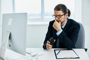 The man in a suit with glasses self-confidence work computer photo