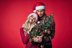 man and woman celebrate christmas happiness romance red background photo