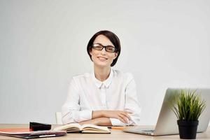 woman in costume in front of laptop with glasses self-confidence light background photo