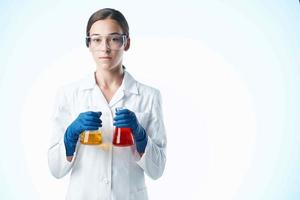 female laboratory assistant chemical solution research science analyzes photo