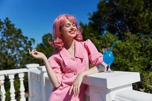 attractive woman drinking a cocktail on the terrace Relaxation concept photo