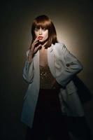 model in beige jacket look at the camera isolated background photo
