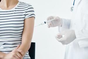 doctor in medical gloves makes an injection in the patient's hand close-up covid photo