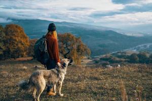 women hikers next to dog walk mountains autumn forest photo