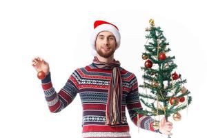 emotional man with a tree in his hands ornaments holiday fun isolated background photo