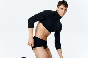 a man with an athletic physique in a sweater underpants and socks photo