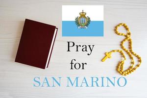 Pray for San Marino. Rosary and Holy Bible background. photo
